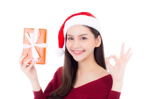 Happy asian woman with smile holding gift box of xmas, Present girl with celebration christmas, girl gesture ok isolated on white background, shopping with season concept.