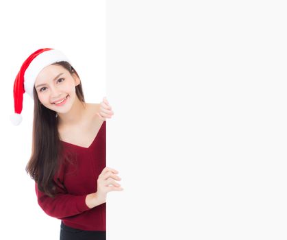 Portrait of beautiful christmas asian young woman in santa hat holding board with copyspace empty isolated on white background, xmas holiday concept.