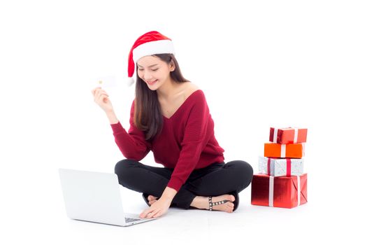 Young woman gift box sitting labtop with internet shopping and holding credit card christmas holiday, girl shoping online on notebook in xmas, celebration concept.