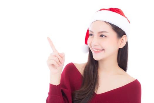 Portrait of beautiful asian young woman pointing something in santa hat smile and happy, girl model isolated on white background, christmas and holiday concept.