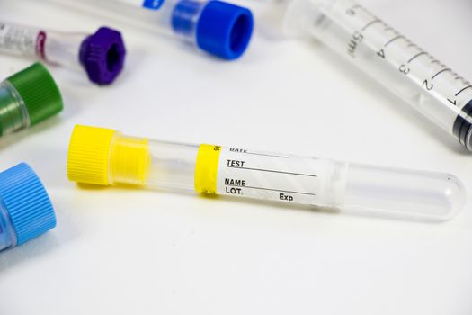 Blood test empty tubes samples on the white background, studio shoot. Colorful tubes, name, date and test.