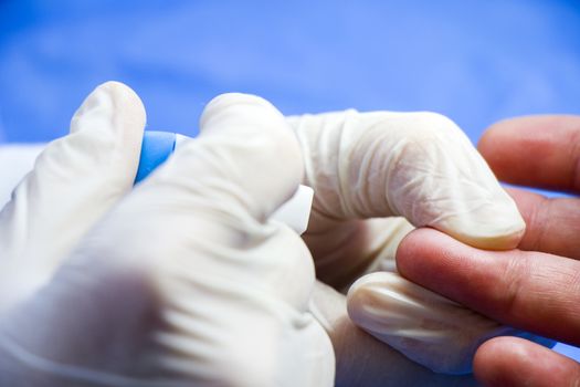 Insulin testing process, blood test and syringe. Injection in the hand. Patients and doctor. Studio shoot.