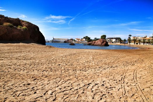 Mazarron, Murcia, Spain- October 3, 2019: Beautiful La Ermita beach in Mazarron, Murcia, Spain. Island in the background.