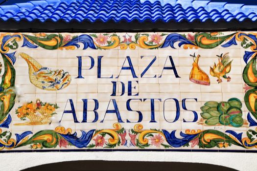 Mazarron, Murcia, Spain- October 3, 2019: Plaza de Abastos phrase written on a ceramic plate on the wall of the food market in Mazarron