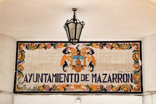 Mazarron, Murcia, Spain- October 3, 2019: Ayuntamiento de Mazarron phrase written on a ceramic plate on the wall of the food market in Mazarron