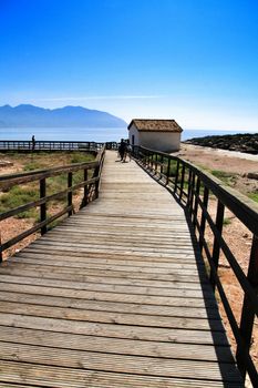 Isla Plana, Murcia, Spain-October 8, 2019:Wooden boardwalk along the beach in a sunny day in Isla Plana village in Cartagena, Murcia, Spain