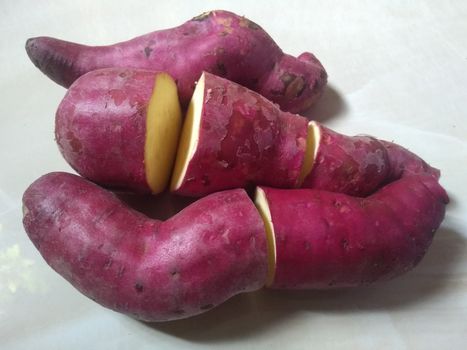 sweet pink potatoes on the white background close up photo