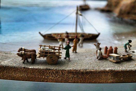 Cartagena, Murcia, Spain- July 27, 2019: Miniature roman figurines displayed in a Cartagena Museum reflecting daily life in roman times