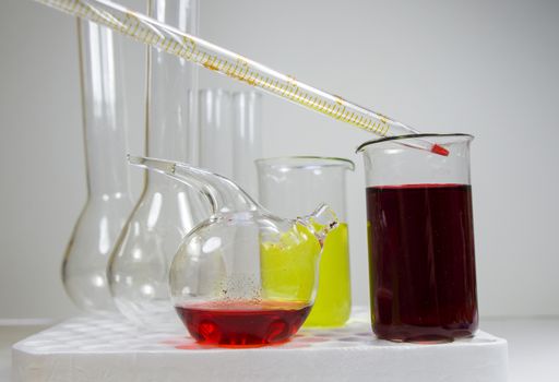 Laboratory chemical liquid elements and research diagnoses, instruments and objects in the sterile table, glassware and pipette. Studio shoot.