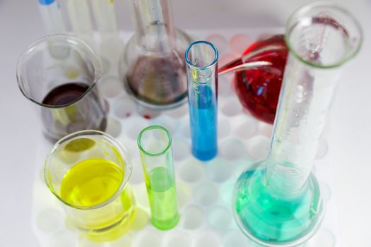 Laboratory chemical liquid elements and research diagnoses, instruments and objects in the sterile table, glassware and pipette.