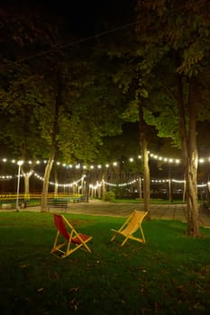 The chairs outside in garden at night.