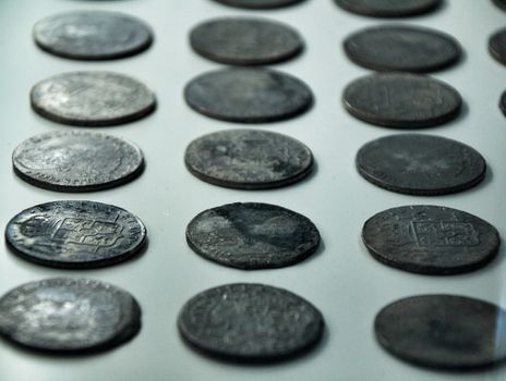 Cartagena, Murcia, Spain- July 25, 2019: Spanish silver coins recovered from the ocean floor by the Odissey company and exposed in underwater museum in Cartagena, Spain