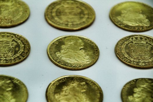 Cartagena, Murcia, Spain- July 25, 2019: Spanish gold coins recovered from the ocean floor by the Odissey company and exposed in underwater museum in Cartagena, Spain