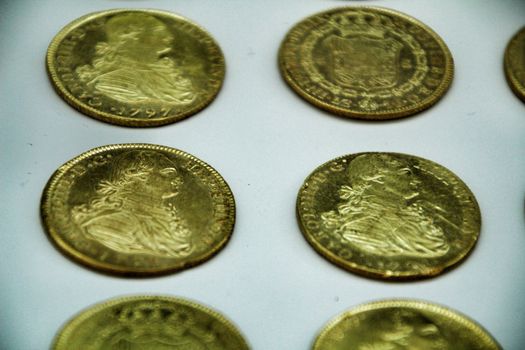 Cartagena, Murcia, Spain- July 25, 2019: Spanish gold coins recovered from the ocean floor by the Odissey company and exposed in underwater museum in Cartagena, Spain