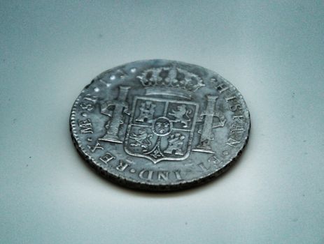 Cartagena, Murcia, Spain- July 25, 2019: Spanish silver coin recovered from the ocean floor by the Odissey company and exposed in underwater museum in Cartagena, Spain