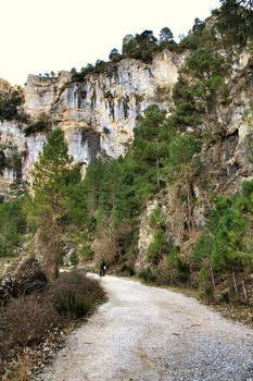 Riopar, Albacete, Spain- February 8, 2019: Walkers through Mountains between with green vegetation in winter in Riopar, Castilla la Mancha, Spain