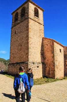 Riopar Viejo, Albacete, Spain- February 8, 2019: Tourists visiting and walking through cobbled stone streets in Riopar Viejo village, Castilla La Mancha, Spain. Sunny day of winter.