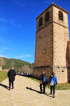 Riopar Viejo, Albacete, Spain- February 8, 2019: Tourists visiting and walking through cobbled stone streets in Riopar Viejo village, Castilla La Mancha, Spain. Sunny day of winter.