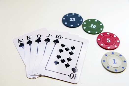 Royal flush poker and blackjack cards and chips, studio shoot.
