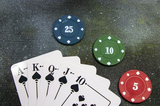Royal flush poker and blackjack cards and chips, studio shoot.