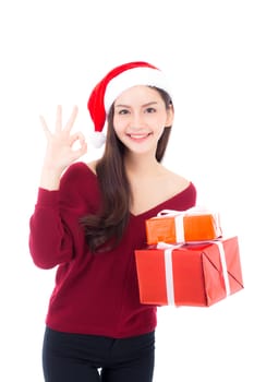 Happy asian woman with smile holding gift box many of xmas, Present girl sign ok with celebration christmas a holiday, girl with buyer isolated on white background.