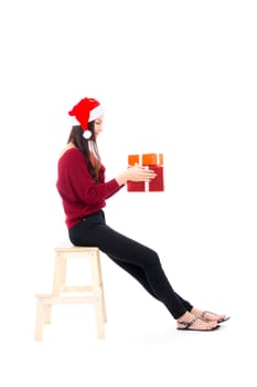 Happy asian woman sitting with smile holding gift box many of xmas, Present girl with celebration christmas a holiday, girl with buyer isolated on white background, shopping concept.