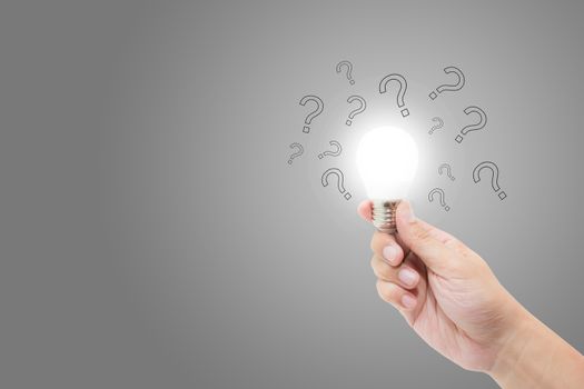 Hand with light bulb and question mark for solution, inspiration and brainstorm, problum and analysis, new idea and imagination of success concept.