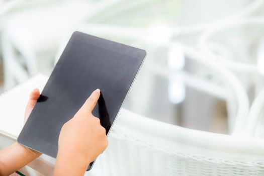 Closeup view of woman holding digital tablet on touch screen device working internet online or open email at office, communication and social networking concept.