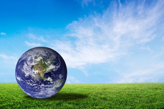 Planet earth beautiful on green grass with cloud sky, world with conservation and resource for renewable, environment concept, Elements of this image furnished by NASA.