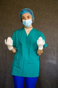 Woman doctors portrait, doctors with mask, glove and uniform. Uniform for surgery and viruses.