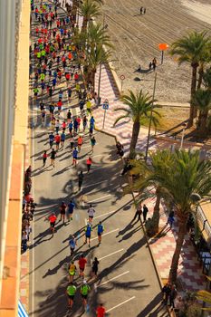 Santa Pola, Spain- January 21, 2018: Runners in the Half Marathon of the fishing village of Santa Pola, province of Alicante, on a sunny day in January