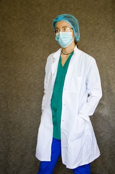 Woman doctors portrait, doctors with mask, glasses, glove and uniform. Uniform for surgery and pandemic.