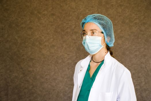 Woman doctors portrait, doctors with mask, glasses, glove and uniform. Uniform for surgery and pandemic.