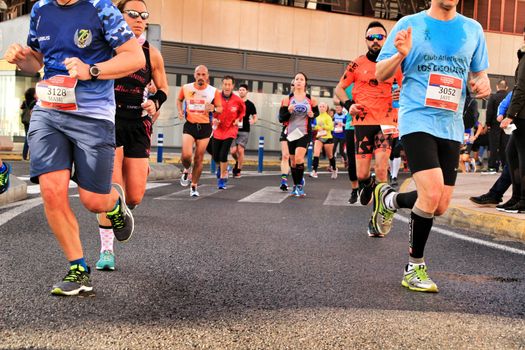 Santa Pola, Spain- January 20, 2019: Runners in the Half Marathon of the fishing village of Santa Pola, province of Alicante, on a sunny day in January