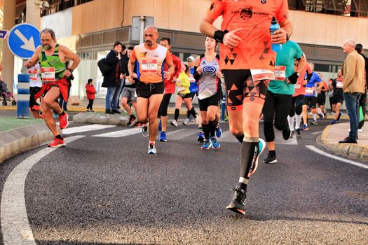 Santa Pola, Spain- January 20, 2019: Runners in the Half Marathon of the fishing village of Santa Pola, province of Alicante, on a sunny day in January