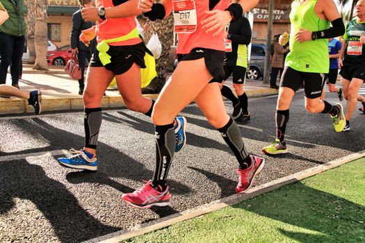 Santa Pola, Spain- January 20, 2019: Runners in the Half Marathon of the fishing village of Santa Pola, province of Alicante, on a sunny day in January