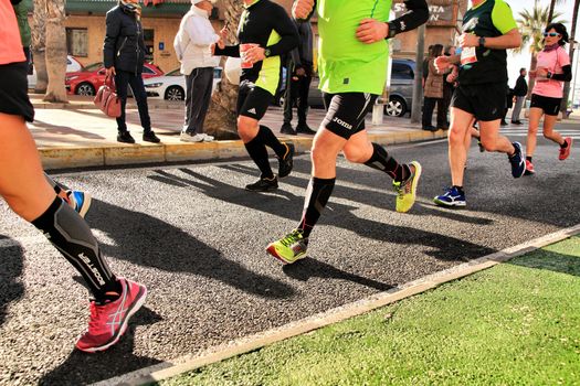 Santa Pola, Spain- January 20, 2019: Runners in the Half Marathon of the fishing village of Santa Pola, province of Alicante, on a sunny day in January