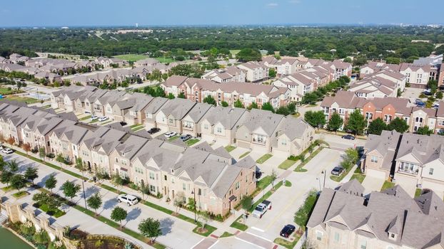 Aerial view of brand new two story condo and townhomes in downtown Flower Mound, Texas, America. Master-planned community and census-designated residential houses and apartment buildings