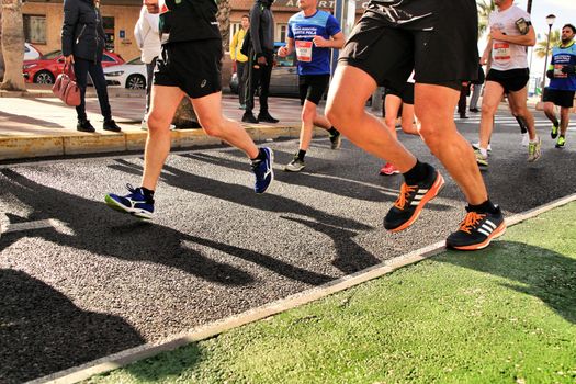 Santa Pola, Spain- January 20, 2019: Runners in the Half Marathon of the fishing village of Santa Pola, province of Alicante, on a sunny day in January