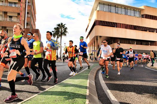 Santa Pola, Spain- January 20, 2019: Runners in the Half Marathon of the fishing village of Santa Pola, province of Alicante, on a sunny day in January