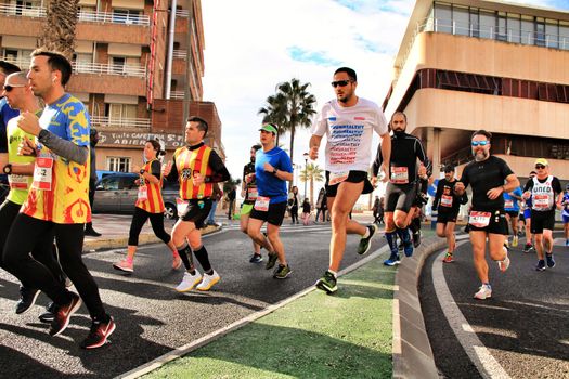 Santa Pola, Spain- January 20, 2019: Runners in the Half Marathon of the fishing village of Santa Pola, province of Alicante, on a sunny day in January