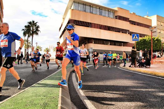 Santa Pola, Spain- January 20, 2019: Runners in the Half Marathon of the fishing village of Santa Pola, province of Alicante, on a sunny day in January
