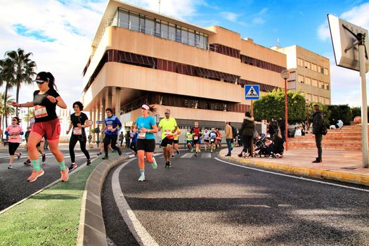 Santa Pola, Spain- January 20, 2019: Runners in the Half Marathon of the fishing village of Santa Pola, province of Alicante, on a sunny day in January