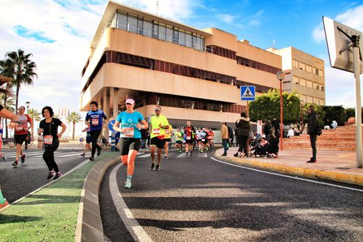 Santa Pola, Spain- January 20, 2019: Runners in the Half Marathon of the fishing village of Santa Pola, province of Alicante, on a sunny day in January