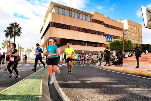 Santa Pola, Spain- January 20, 2019: Runners in the Half Marathon of the fishing village of Santa Pola, province of Alicante, on a sunny day in January