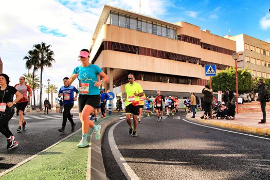Santa Pola, Spain- January 20, 2019: Runners in the Half Marathon of the fishing village of Santa Pola, province of Alicante, on a sunny day in January