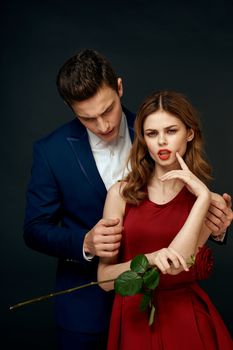 luxury couple hug romance relationship rose over dark isolated background. High quality photo