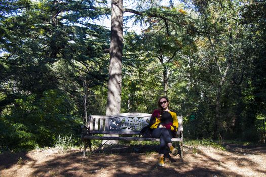 Woman in the botanic garden and park, trees and casual young girl portrait in garden