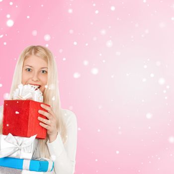 Happy woman holding Christmas gifts, pink background and snow glitter with copyspace, shopping and holidays