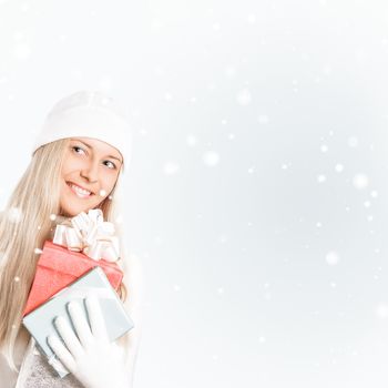 Happy woman holding Christmas gifts, silver background and snow glitter with copyspace, shopping and holidays